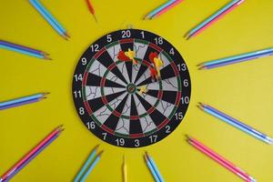 Dart board and a desk. Workspace with a target and a successful business growth concept, as well as a dart board with a target. photo