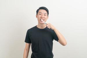 portrait young Asian man brush teeth photo