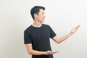 Asian man with hand pointing or presenting on white background photo