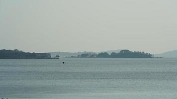 The beautiful lake landscapes in the Hangzhou city of the China in spring with the peaceful lake and fresh green mountains photo