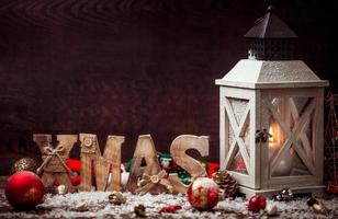 Christmas Lantern on snowy table with festive decoration. photo