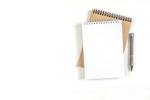 Two blank spiral notepads and pen photo