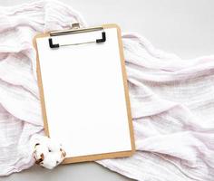 Clipboard and cotton flower photo