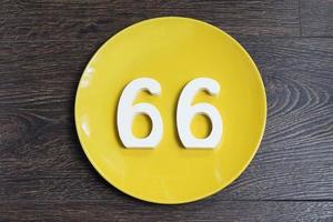 The number sixty-six on the yellow plate. photo