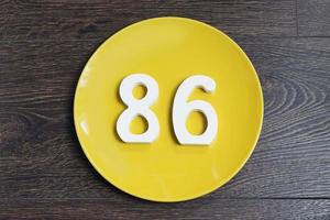 The number eighty-six on the yellow plate. photo