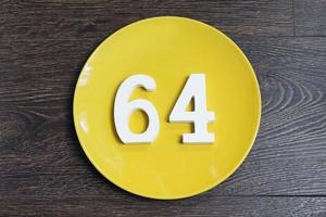 The number sixty-four on the yellow plate. photo
