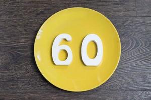 The number sixty on the yellow plate. photo