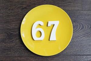 The number sixty-seven on the yellow plate. photo