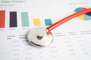 Stethoscope on charts and graphs paper, Finance, Account, Statistics, Investment, Analytic research data economy and Business company concept. photo