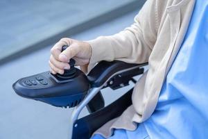 Asian senior or elderly old lady woman patient on electric wheelchair with remote control at nursing hospital ward, healthy strong medical concept photo