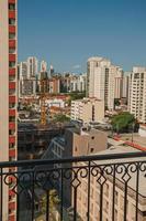 City skyline seen from a balcony in a building in Sao Paulo. The gigantic city, famous for its cultural and business vocation in Brazil. photo