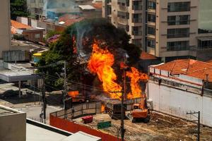Huge fire flame caused by a gas leak in a pipe under a street in Sao Paulo. The city famous for its cultural and business vocation in Brazil. photo