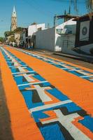 Sao Manuel, Brazil - May 31, 2018. Artistic colorful sand carpet made by the devotees for the celebration of Holy Week on the street of Sao Manuel. A little town in the countryside of Sao Paulo State. photo