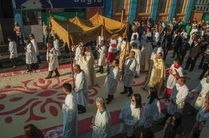 Sao Manuel, Brazil - May 31, 2018. Crowd with religious procession passing by a colorful sand carpet at the celebration of Holy Week in Sao Manuel. A little town in the countryside of Sao Paulo State. photo