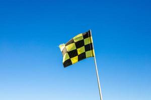 A golf flag against a blue sky photo