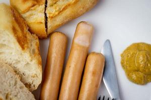 Sausages with a crispy roll. Delicious breakfast. photo