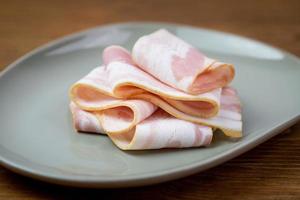 Raw bacon slices. Component of a protein and fat breakfast. photo