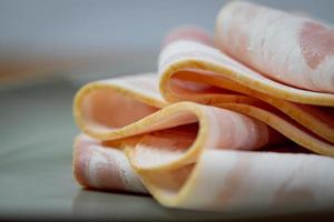 Raw bacon slices. Component of a protein and fat breakfast. photo