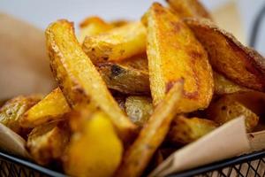 Golden, home-made, coarse-cut potato fries. photo