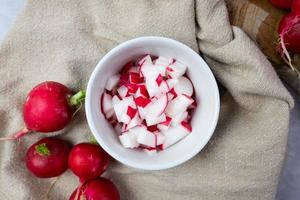 Chopped radish in a bowl. Preparation of ingredients for food. Top view. photo