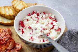 Cottage cheese with radish, ham, tomatoes, and fresh bread. Delicious breakfast. photo