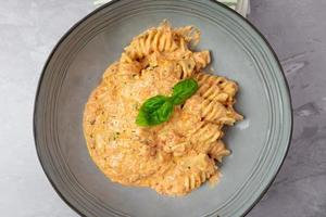 Spiral pasta with paprika pesto. Top view. photo