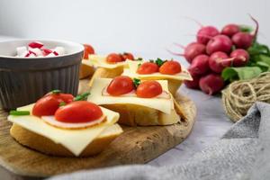 Sandwiches with cheese, tomato and radish. Delicious and healthy breakfast. photo