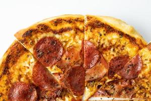 Homemade pizza with cheese and salami.