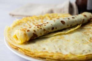 Crepes, French-style pancakes. Wrapped with plum jam. photo