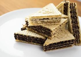 Wafers with cocoa filling on a plate. photo