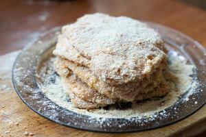 Breaded pork chop lying on a plate. Traditional dinner. photo