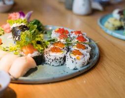 un plato de sushi. diferentes tipos de comida japonesa. deliciosa comida en el restaurante durante la reunión. foto