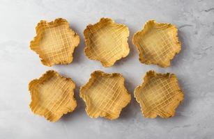 Empty waffle ice cream bowls top view white background photo