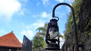 Antique street lights with sky background. worn lantern isolated with blurred background photo