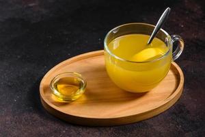 Tea with sea buckthorn on dark background photo