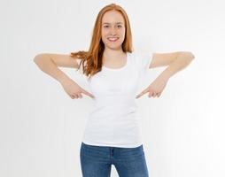 Beautiful red hair girl pointed on a white t-shirt isolated. Pretty smile red head woman in tshirt mock up, blank. photo