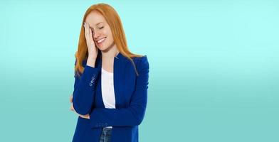 Woman do face palm, girl make facepalm, female migraine, head pain, bad feeling, tired woman - blue background photo