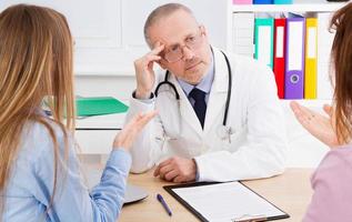Doctor and patients discussing something in medical office . Medicine and health care concept. Doctor and patient photo
