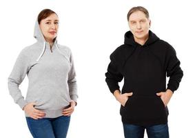 Couple wearing hoody. man has black hoodie. Woman has grey hoodie photo