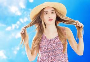 Pretty lady in summer hat - vacation summer concept isolated over blue background photo