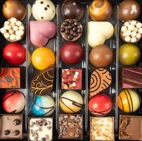 Various types of pralines. Delicious looking chocolates. Top view. photo