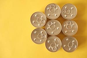 Canned food closed on yellow background photo