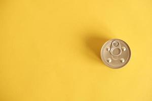 Canned food closed on yellow background photo