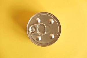 Canned food closed on yellow background photo