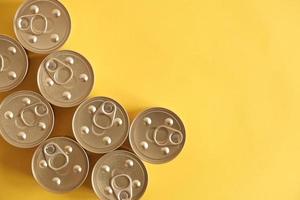 Canned food closed on yellow background photo