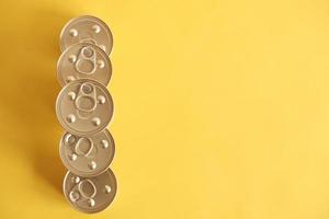 Canned food closed on yellow background photo