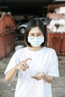 Women wearing white shirts that press the gel to wash hands to clean hands. photo