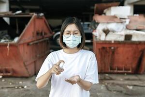 Women wearing white shirts that press the gel to wash hands to clean hands. photo