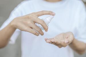 Women wearing white shirts that press the gel to wash hands to clean hands. photo