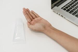 Women wearing white shirts that press the gel to wash hands to clean hands. photo